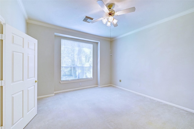 spare room featuring carpet, ornamental molding, baseboards, and a ceiling fan
