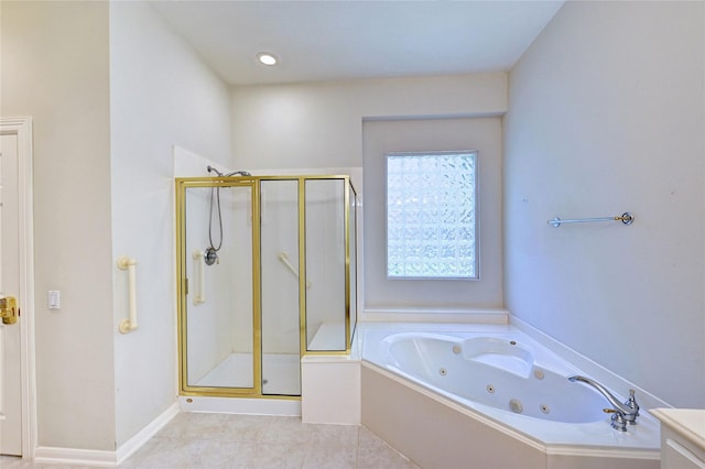 bathroom featuring a stall shower, a tub with jets, and tile patterned floors