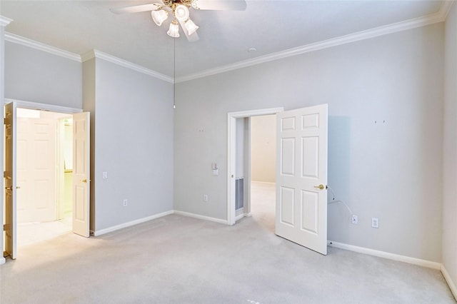 unfurnished bedroom with light carpet, ornamental molding, baseboards, and ceiling fan