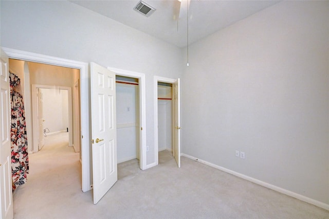 unfurnished bedroom with light carpet and baseboards