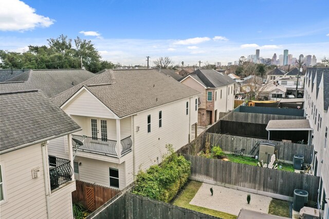 4609 Sharman St, Houston, TX 77009 - back of property featuring a fenced backyard, central AC, a balcony, and roof with shingles