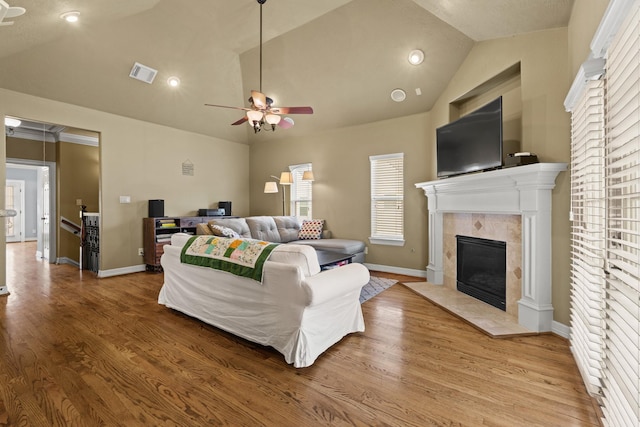 4609 Sharman St, Houston, TX 77009 - living room with lofted ceiling, a fireplace, ceiling fan, baseboards, and wood finished floors