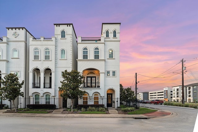 2725 Kennedy St, Houston, TX 77003 - view of front of property featuring a balcony, fence, and stucco siding