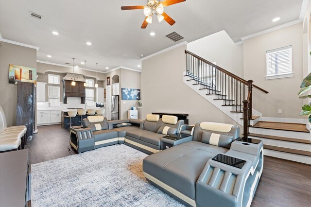 2725 Kennedy St, Houston, TX 77003 - living room with a ceiling fan, recessed lighting, dark wood-style floors, stairs, and ornamental molding