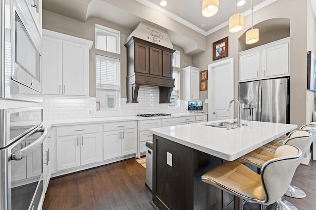 2725 Kennedy St, Houston, TX 77003 - kitchen with a sink, appliances with stainless steel finishes, crown molding, light countertops, and tasteful backsplash