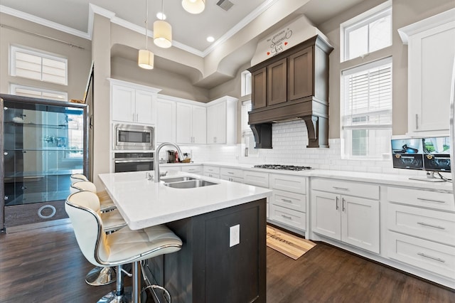 2725 Kennedy St, Houston, TX 77003 - kitchen with a sink, appliances with stainless steel finishes, ornamental molding, dark wood-style flooring, and light countertops