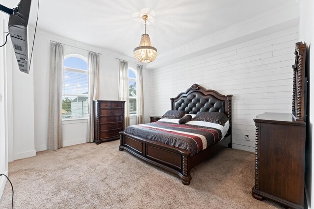 2725 Kennedy St, Houston, TX 77003 - bedroom featuring light colored carpet, baseboards, wood walls, ornamental molding, and a chandelier