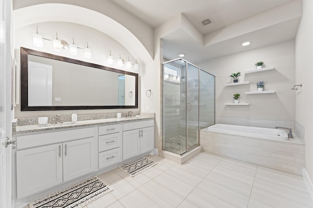 2725 Kennedy St, Houston, TX 77003 - bathroom featuring a bath, a stall shower, double vanity, tile patterned floors, and recessed lighting