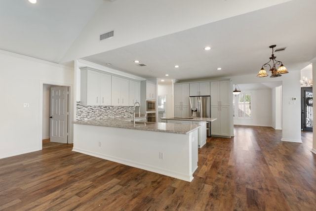 11623 Aspenway Dr, Houston, TX 77070 - kitchen featuring a peninsula, tasteful backsplash, a sink, light stone countertops, and dark wood-type flooring