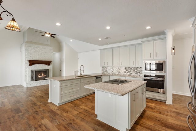11623 Aspenway Dr, Houston, TX 77070 - kitchen featuring stainless steel appliances, a peninsula, backsplash, open floor plan, and a ceiling fan