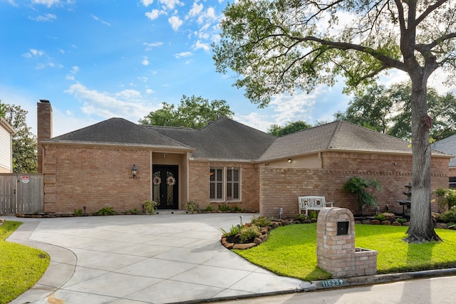 11623 Aspenway Dr, Houston, TX 77070 - ranch-style home with brick siding, driveway, roof with shingles, and a front lawn