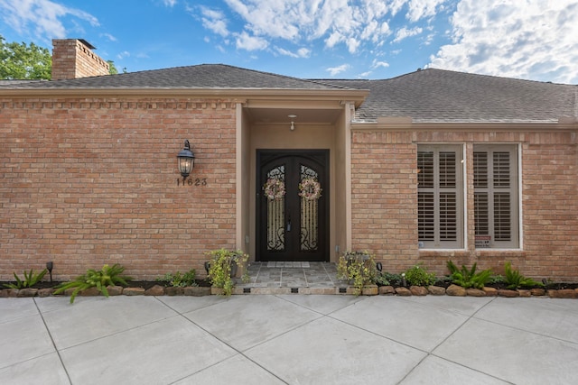 11623 Aspenway Dr, Houston, TX 77070 - entrance to property with brick siding, a chimney, and roof with shingles