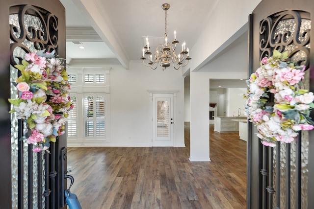 11623 Aspenway Dr, Houston, TX 77070 - foyer entrance with a chandelier, beamed ceiling, wood finished floors, and crown molding