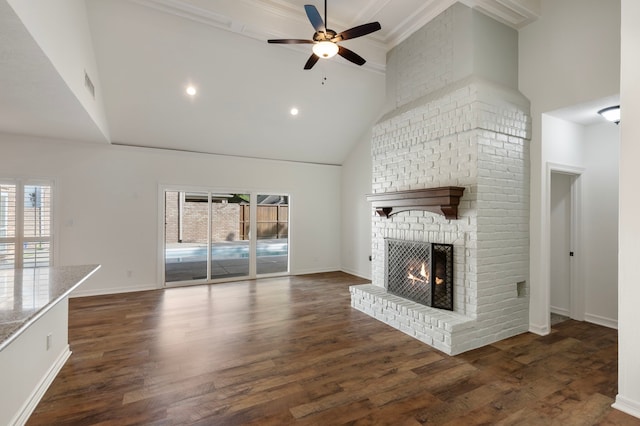 11623 Aspenway Dr, Houston, TX 77070 - unfurnished living room featuring high vaulted ceiling, a brick fireplace, ceiling fan, plenty of natural light, and wood finished floors