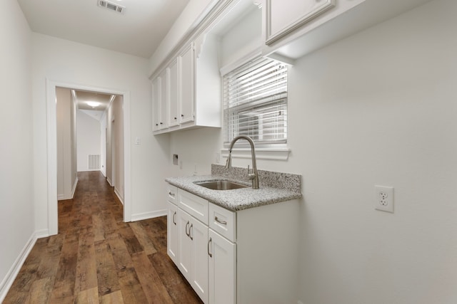 11623 Aspenway Dr, Houston, TX 77070 - kitchen with a sink, white cabinetry, dark wood-style flooring, light stone counters, and baseboards