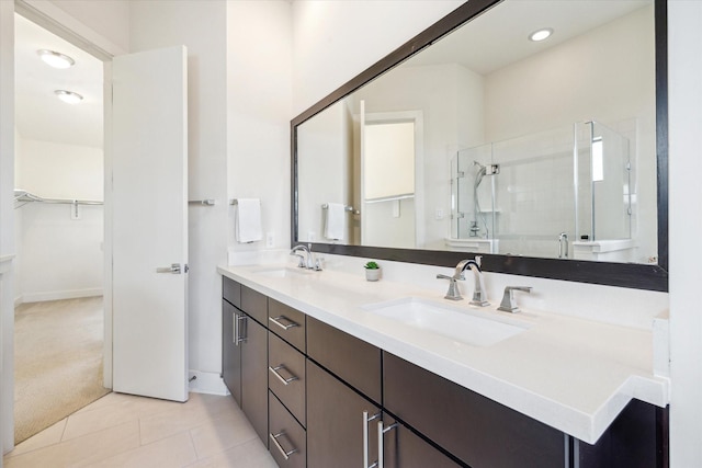 1704 Alamo St Unit A, Houston, TX 77007 - bathroom featuring a shower stall, a spacious closet, tile patterned flooring, double vanity, and baseboards