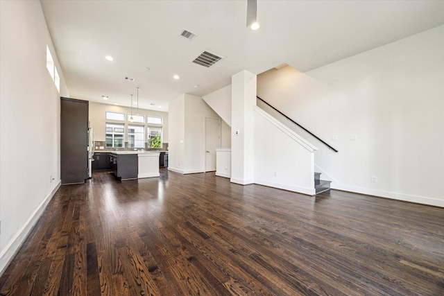 1704 Alamo St Unit A, Houston, TX 77007 - unfurnished living room with dark wood finished floors, stairs, baseboards, and recessed lighting