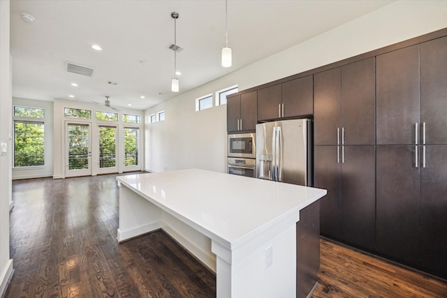 1704 Alamo St Unit A, Houston, TX 77007 - kitchen featuring stainless steel appliances, dark brown cabinetry, light countertops, dark wood finished floors, and recessed lighting