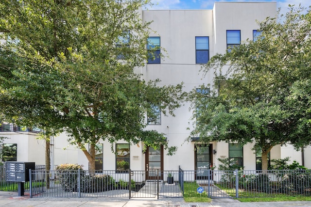 1704 Alamo St Unit A, Houston, TX 77007 - view of front of house featuring stucco siding, fence, and a gate