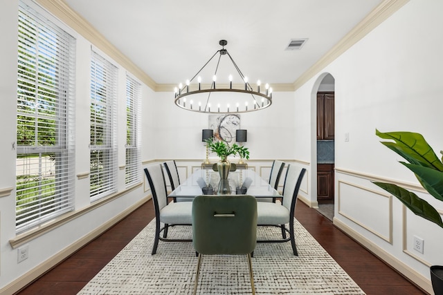 4603 Red Hawk Ct, Sugar Land, TX 77479 - dining area with arched walkways, ornamental molding, dark wood-style flooring, and a chandelier