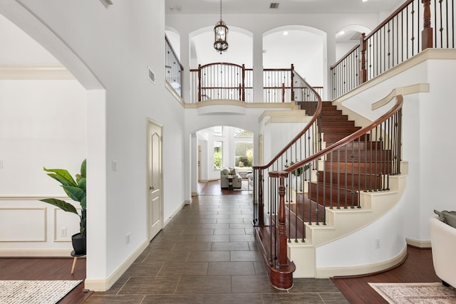 4603 Red Hawk Ct, Sugar Land, TX 77479 - entryway featuring stairs, a high ceiling, a chandelier, and dark wood-style flooring