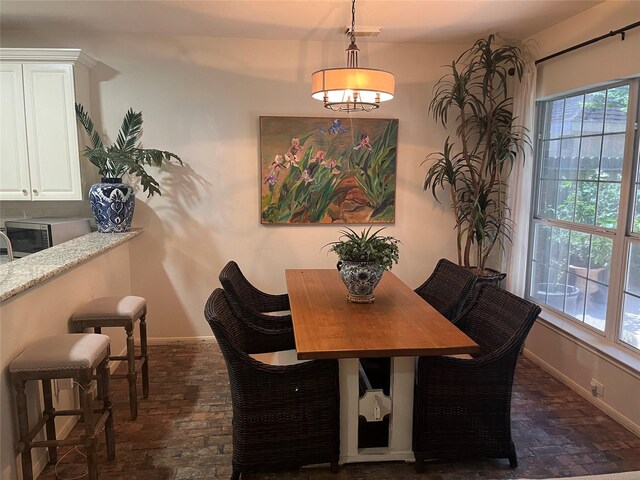 2103 Crescent Coral Dr, League City, TX 77573 - dining room featuring brick floors and baseboards