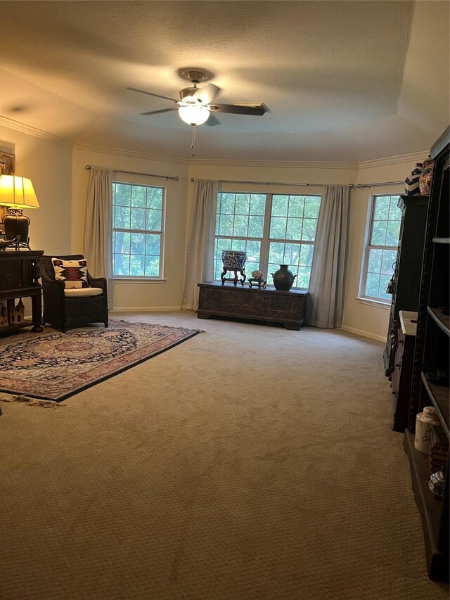 2103 Crescent Coral Dr, League City, TX 77573 - carpeted living room featuring crown molding, a ceiling fan, and baseboards