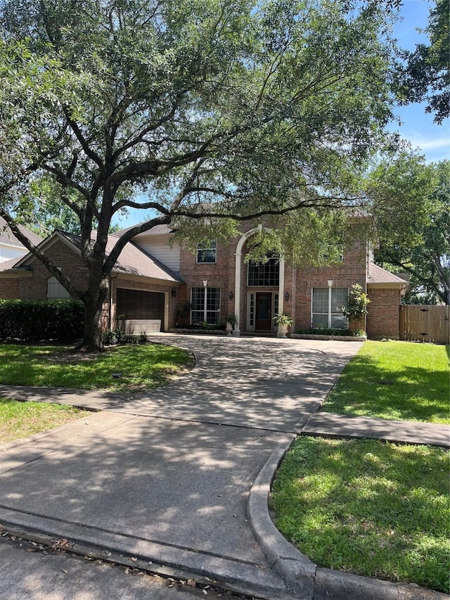 2103 Crescent Coral Dr, League City, TX 77573 - view of front facade featuring brick siding, driveway, and a garage