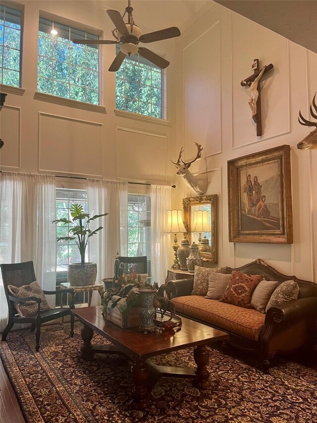2103 Crescent Coral Dr, League City, TX 77573 - living area featuring a high ceiling, ceiling fan, and a decorative wall