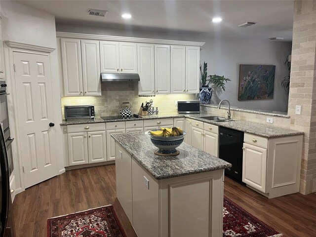 2103 Crescent Coral Dr, League City, TX 77573 - kitchen featuring black appliances, a sink, under cabinet range hood, dark wood-style floors, and a center island