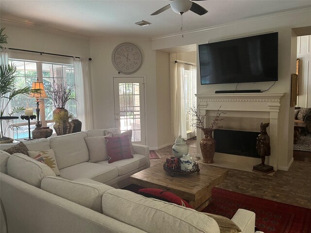 2103 Crescent Coral Dr, League City, TX 77573 - living room with a ceiling fan, a fireplace with flush hearth, baseboards, and ornamental molding