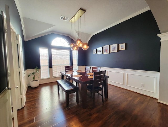 2310 Megellan Point Ln, Pearland, TX 77584 - dining area with lofted ceiling, a wainscoted wall, dark wood-type flooring, ornamental molding, and a chandelier