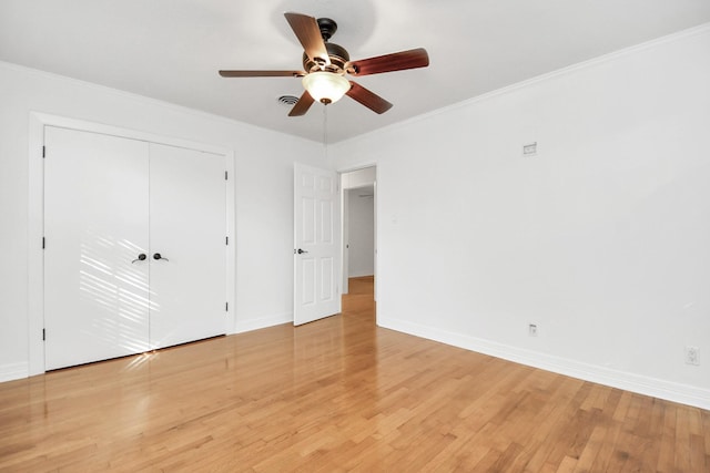 2606 Droxford Dr, Houston, TX 77008 - unfurnished bedroom with light wood-type flooring, baseboards, a closet, crown molding, and ceiling fan