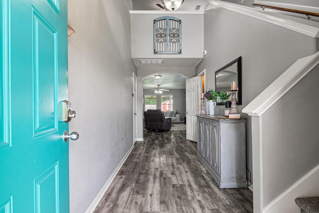 2023 Briar Grove Dr, Conroe, TX 77301 - foyer with wood finished floors, ceiling fan, baseboards, crown molding, and arched walkways
