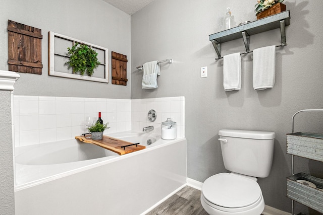 2023 Briar Grove Dr, Conroe, TX 77301 - bathroom featuring toilet, wood finished floors, a garden tub, and baseboards