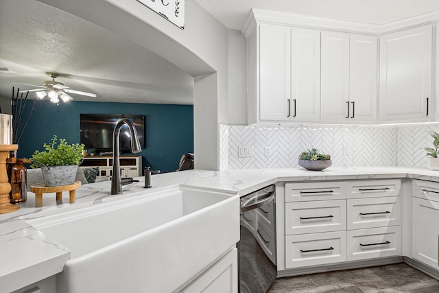 2023 Briar Grove Dr, Conroe, TX 77301 - kitchen featuring a sink, dishwasher, tasteful backsplash, and white cabinets