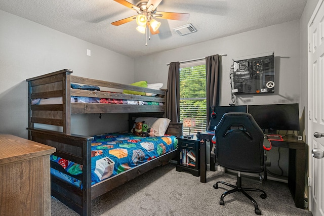 2023 Briar Grove Dr, Conroe, TX 77301 - carpeted bedroom with a textured ceiling, a ceiling fan, and a desk