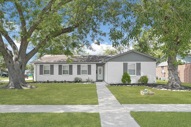 ranch-style house with a front lawn and brick siding