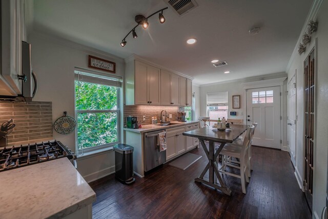 2316 Hollywood Ave, Galveston, TX 77551 - kitchen featuring a sink, stainless steel appliances, light countertops, ornamental molding, and white cabinetry