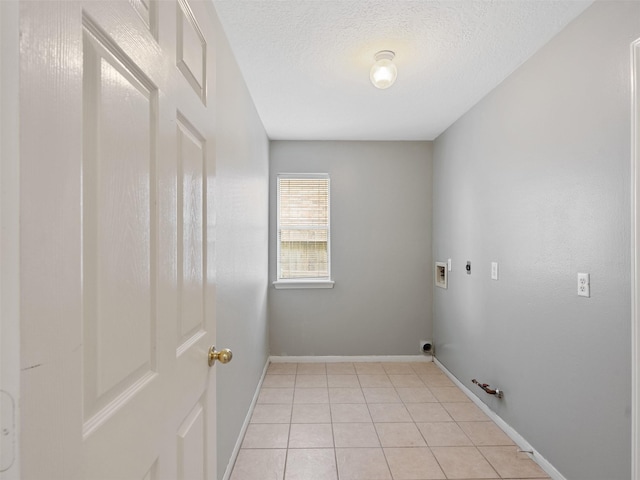 6123 Dove Fern Ct, Houston, TX 77041 - laundry room with gas dryer hookup, hookup for an electric dryer, hookup for a washing machine, light tile patterned floors, and a textured ceiling