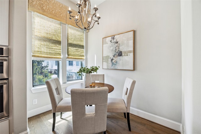 4404 Dickson St Unit B, Houston, TX 77007 - dining area with a chandelier, wood finished floors, and baseboards