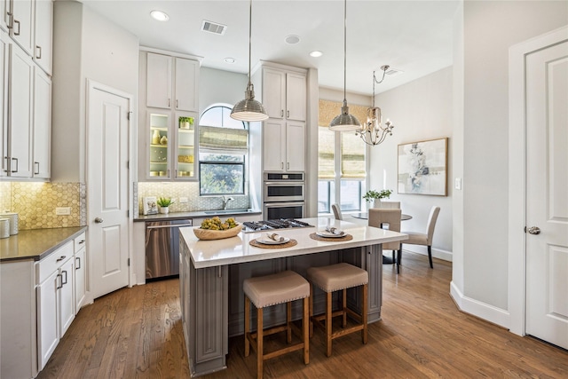 4404 Dickson St Unit B, Houston, TX 77007 - kitchen with stainless steel appliances, a sink, tasteful backsplash, dark wood-style floors, and recessed lighting