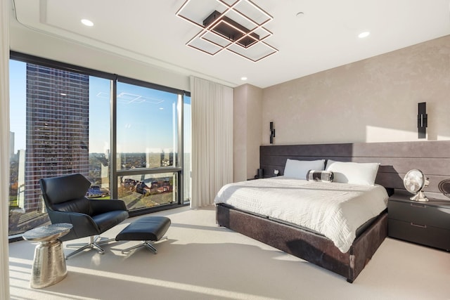 carpeted bedroom featuring recessed lighting and a chandelier