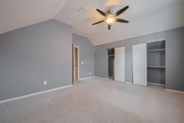 9911 Villa Verde Dr, Houston, TX 77064 - unfurnished bedroom with vaulted ceiling, two closets, carpet flooring, a textured ceiling, and a ceiling fan