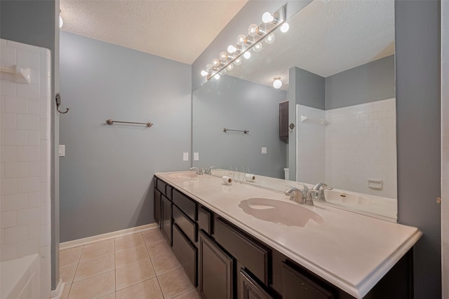 9911 Villa Verde Dr, Houston, TX 77064 - full bathroom featuring a textured ceiling, tile patterned flooring, double vanity, baseboards, and shower / washtub combination