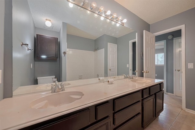 9911 Villa Verde Dr, Houston, TX 77064 - full bathroom with a textured ceiling, toilet, tiled shower, tile patterned floors, and baseboards