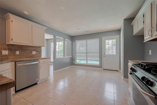 9911 Villa Verde Dr, Houston, TX 77064 - kitchen featuring stainless steel dishwasher, gas range oven, plenty of natural light, baseboards, and a textured ceiling