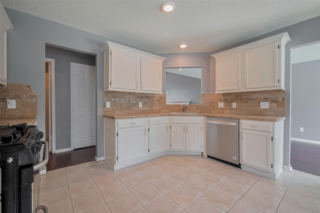 9911 Villa Verde Dr, Houston, TX 77064 - kitchen featuring dishwasher, gas range, light countertops, a sink, and a textured ceiling