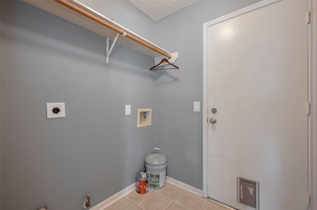 9911 Villa Verde Dr, Houston, TX 77064 - clothes washing area with hookup for a washing machine, hookup for an electric dryer, light tile patterned flooring, baseboards, and a textured ceiling