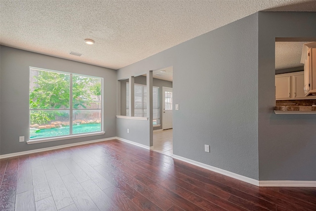 9911 Villa Verde Dr, Houston, TX 77064 - unfurnished room with a textured ceiling, a textured wall, wood finished floors, and baseboards